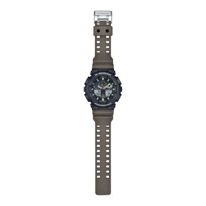 Reloj Casio G-Shock GA-100TU-1A3ER esfera negra y exterior beige.