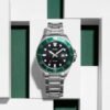 Reloj Casio con esfera negra y la carcasa de color verde mientras que la correa es plateada.