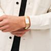 Reloj Daniel Wellington esfera en dorado y en blanco y exterior dorado.