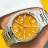Reloj Citizen esfera naranja con toques plateados y con correa plateada de acero.